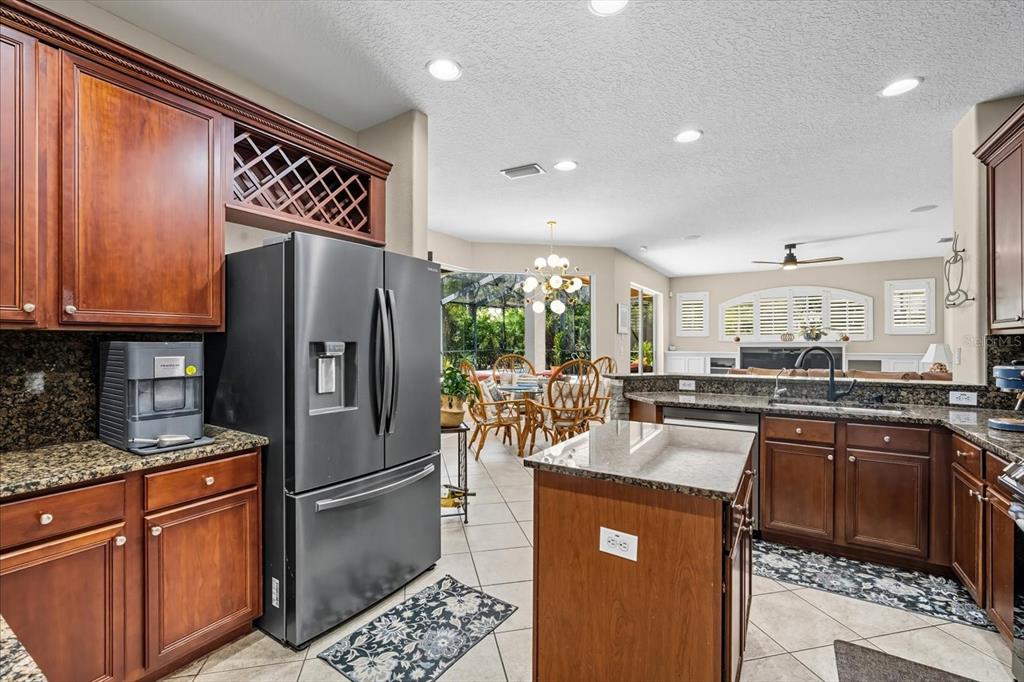 6107 Ibispark Drive Lithia, FL 33547 - Photo 9 of 42 a kitchen with stainless steel appliances granite countertop a refrigerator a stove a sink and a microwave