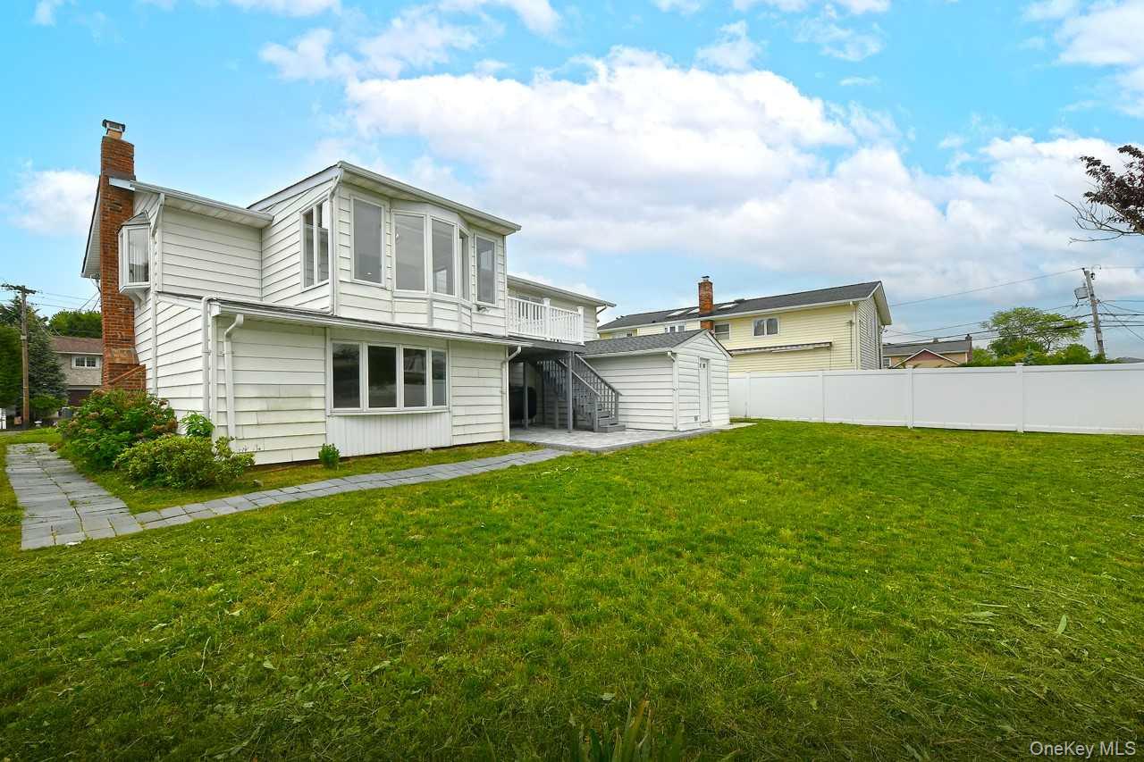 107 Beverly Road Massapequa, NY 11758 - Photo 31 of 41 a view of a house with a backyard