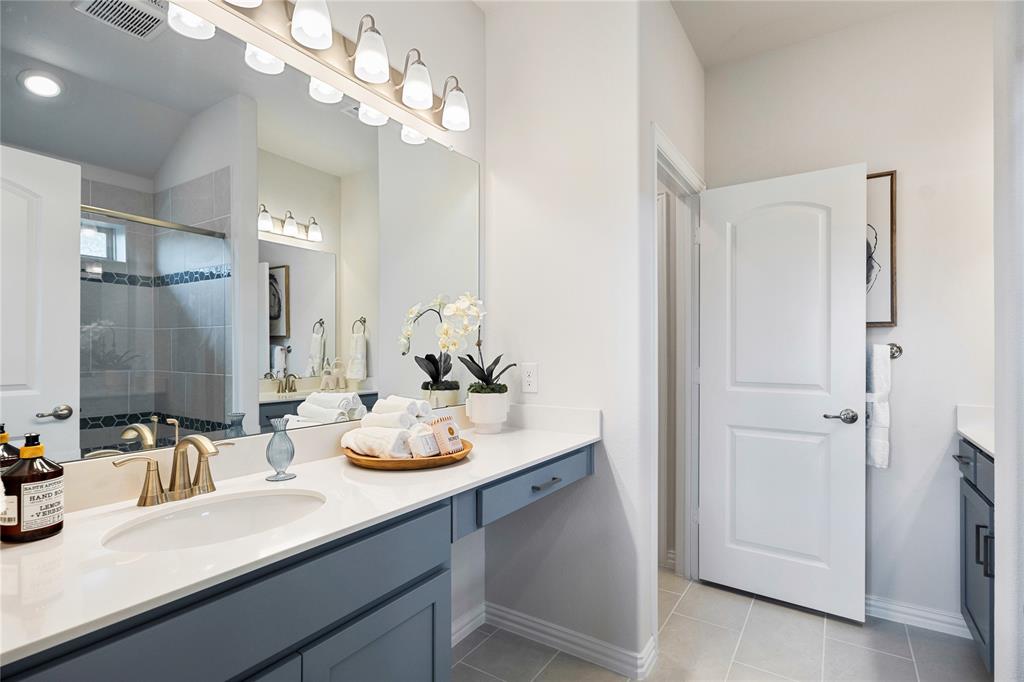 8716 Saratoga Street Pilot Point, TX 76258 - Photo 8 of 16 a bathroom with a sink double vanity and a mirror