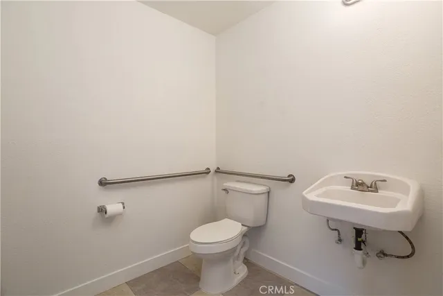 a bathroom with a sink toilet and a mirror