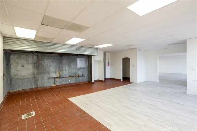 a view of an empty room with a fireplace