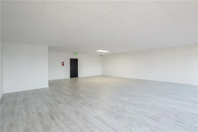 a view of an empty room and wooden floor