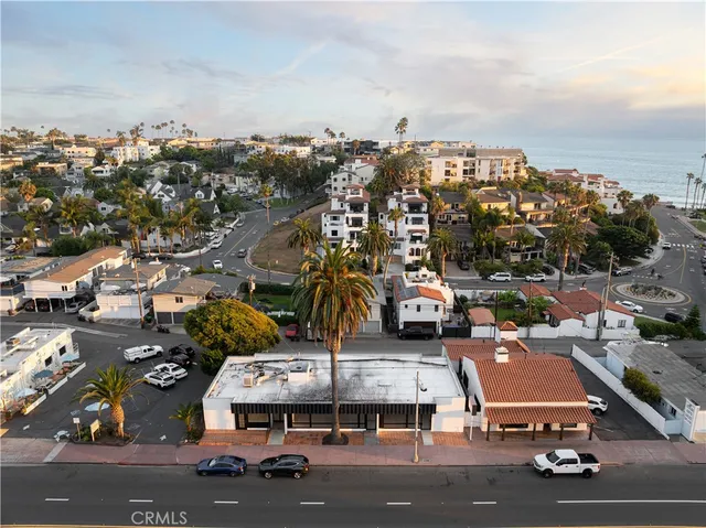 an aerial view of residential houses with city view