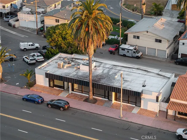 a view of a cars park in front of a building