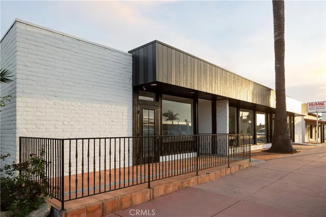 a view of a house with wooden fence