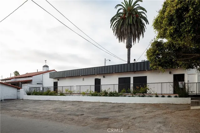 a front view of house with yard and trees