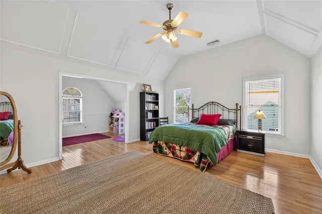 a bedroom with a bed and wooden floor