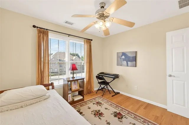 a view of a hallway with wooden floor and a workspace