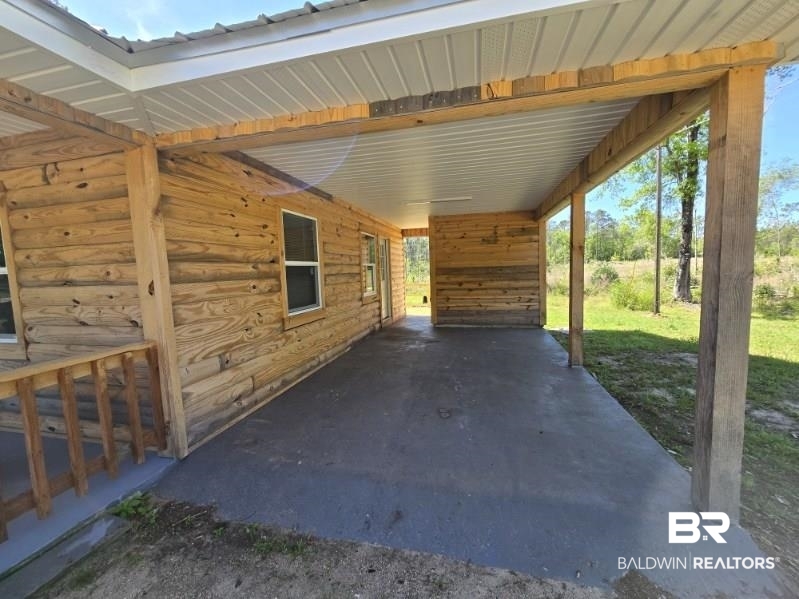 6464 Ridge Road Brewton, AL 36426 - Photo 4 of 14 View of patio featuring a carport