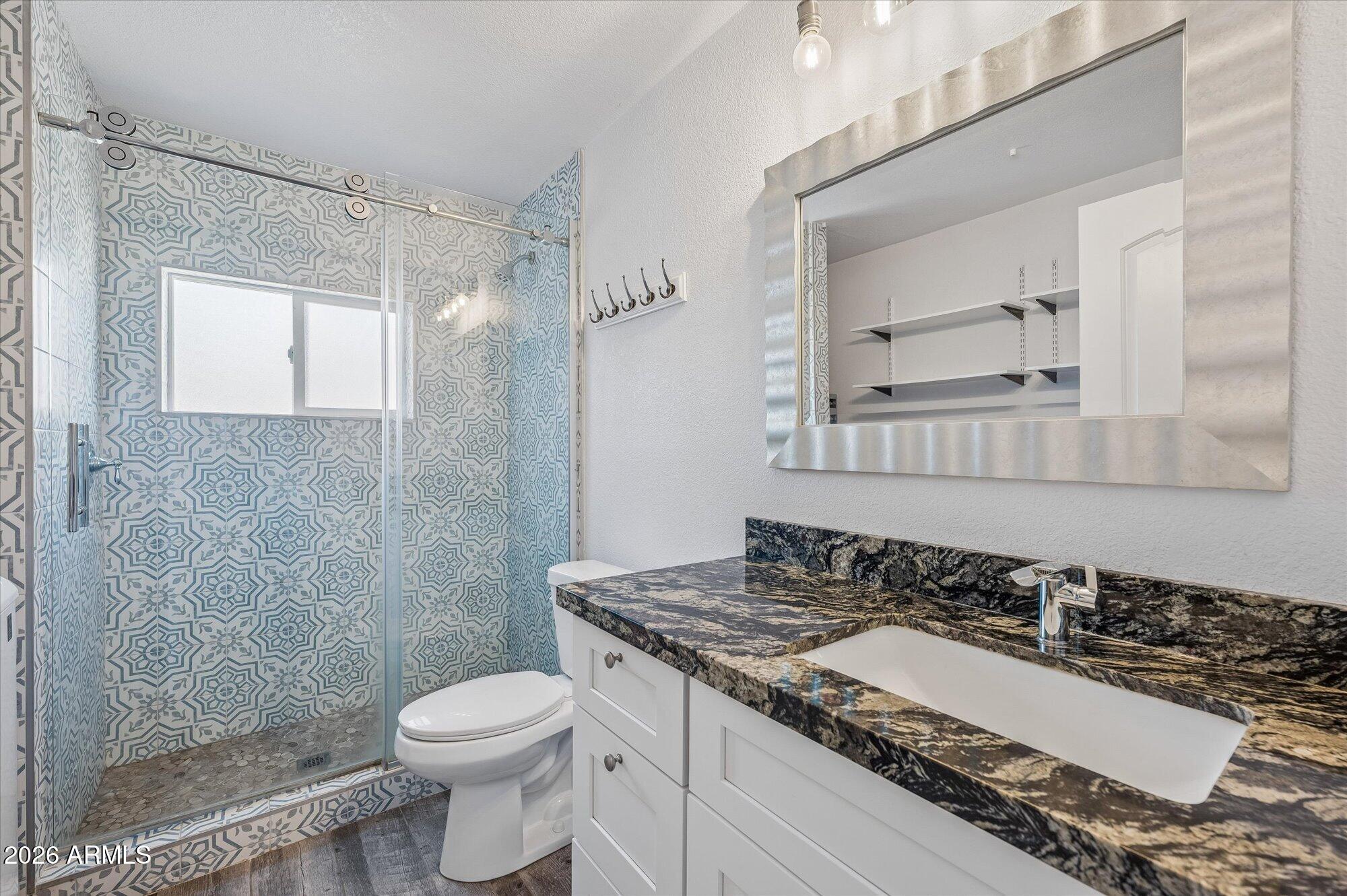 2218 East Yale Street Phoenix, AZ 85006 - Photo 17 of 35 a bathroom with a granite countertop sink toilet and shower