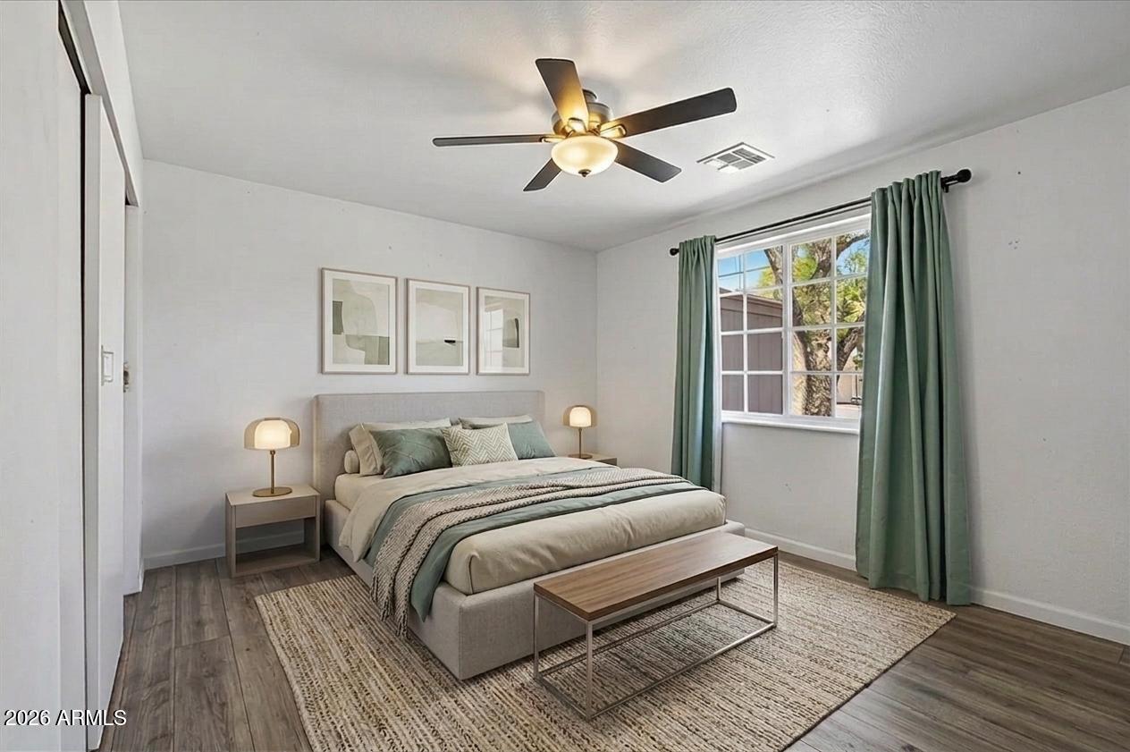 2218 East Yale Street Phoenix, AZ 85006 - Photo 18 of 35 a bedroom with a large bed chandelier and a window
