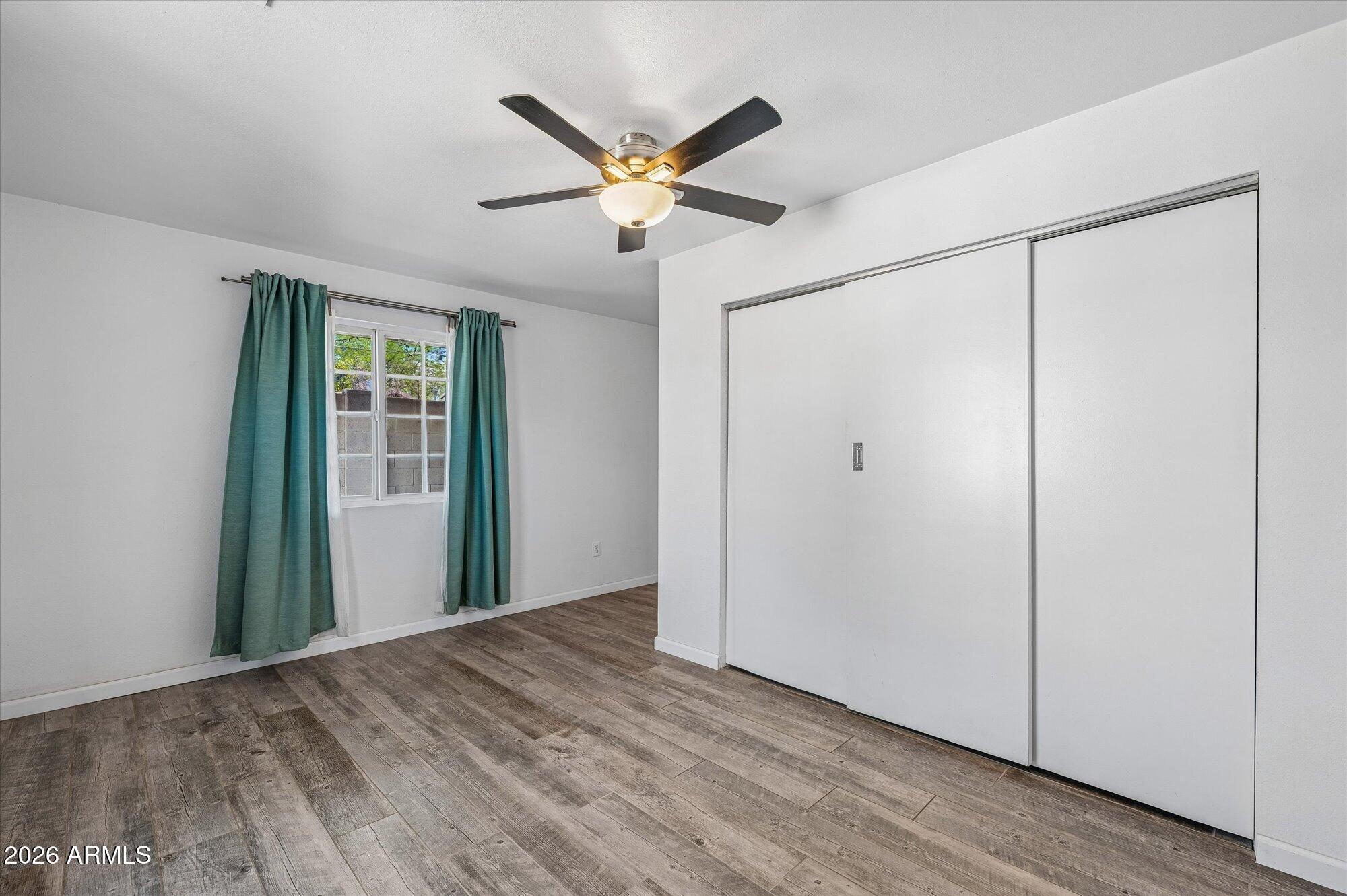 2218 East Yale Street Phoenix, AZ 85006 - Photo 20 of 35 a view of a livingroom with a ceiling fan and wooden floor