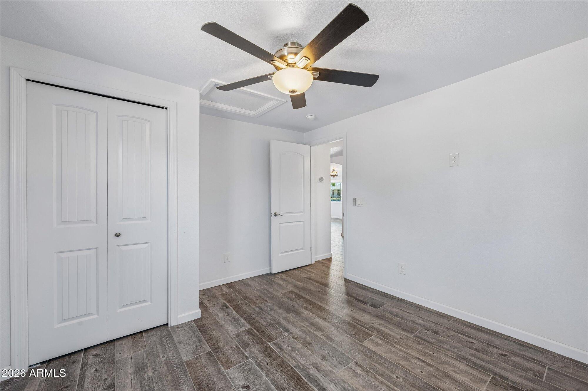 2218 East Yale Street Phoenix, AZ 85006 - Photo 28 of 35 an empty room with wooden floor and ceiling fan