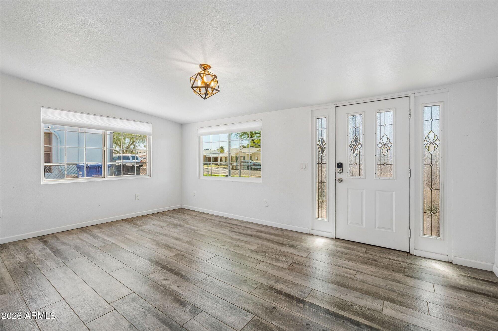 2218 East Yale Street Phoenix, AZ 85006 - Photo 5 of 35 an empty room with wooden floor and windows