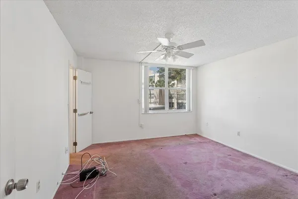 a view of a room with a chandelier fan and bathroom