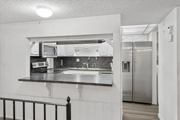 a kitchen with stainless steel appliances a refrigerator and cabinets