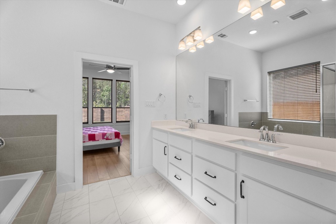 5030 Vly Wind Court Spring, TX 77386 - Photo 19 of 36 Ensuite bath with dual sinks and upgraded lighting.