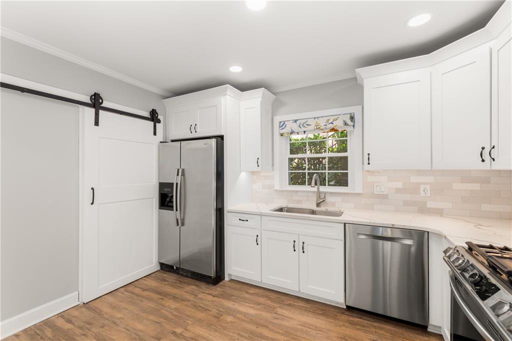 109 Mt Vernon Circle Sandy Springs, GA 30338 - Photo 14 of 37 a kitchen with white cabinets and white appliances