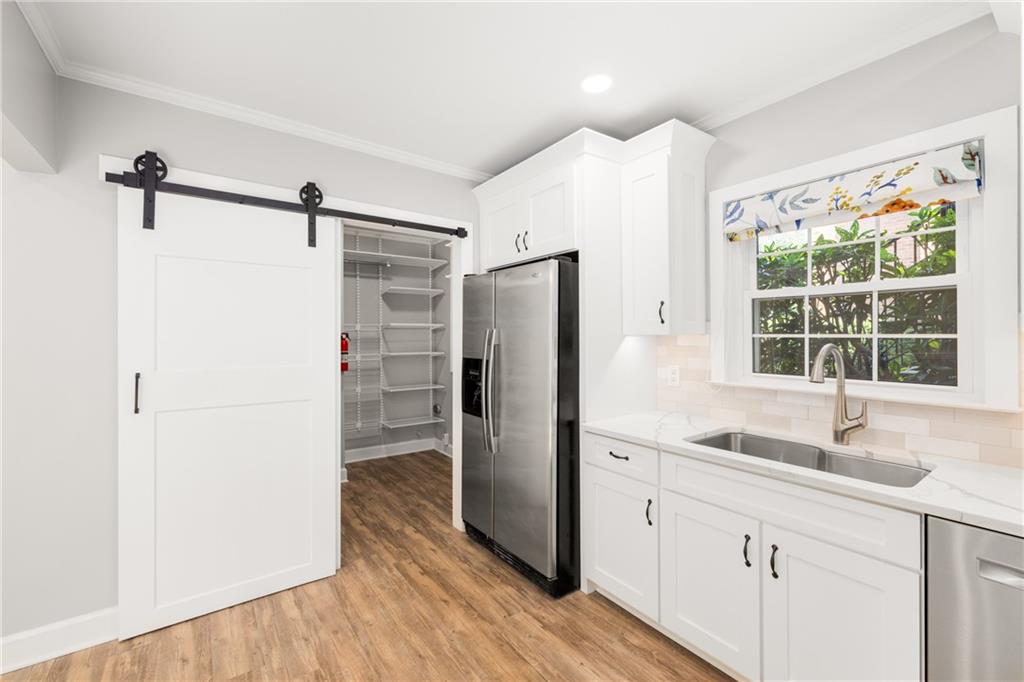 109 Mt Vernon Circle Sandy Springs, GA 30338 - Photo 16 of 37 a kitchen with stainless steel appliances a refrigerator and a sink