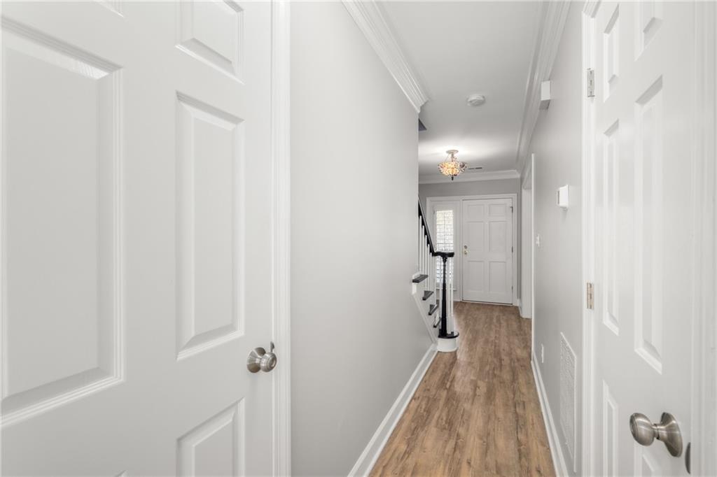 109 Mt Vernon Circle Sandy Springs, GA 30338 - Photo 18 of 37 a view of a hallway with wooden floor and staircase