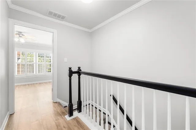 a view of hallway with wooden floor