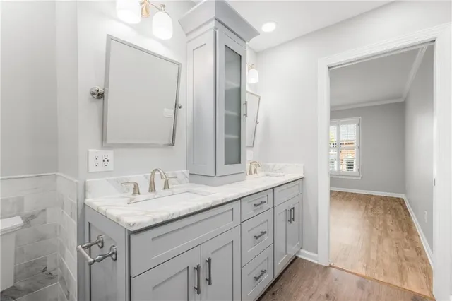 a bathroom with 2 sink and a mirror