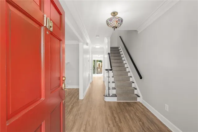 a view of entryway with stairs and wooden floor