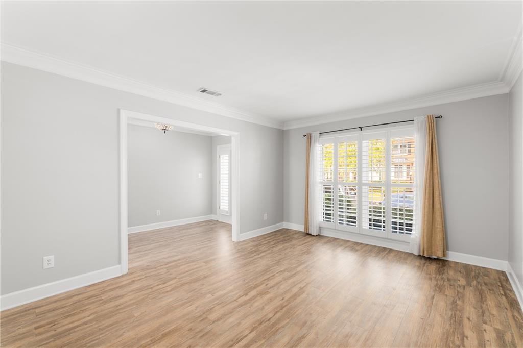 109 Mt Vernon Circle Sandy Springs, GA 30338 - Photo 8 of 37 a view of an empty room with wooden floor and a window