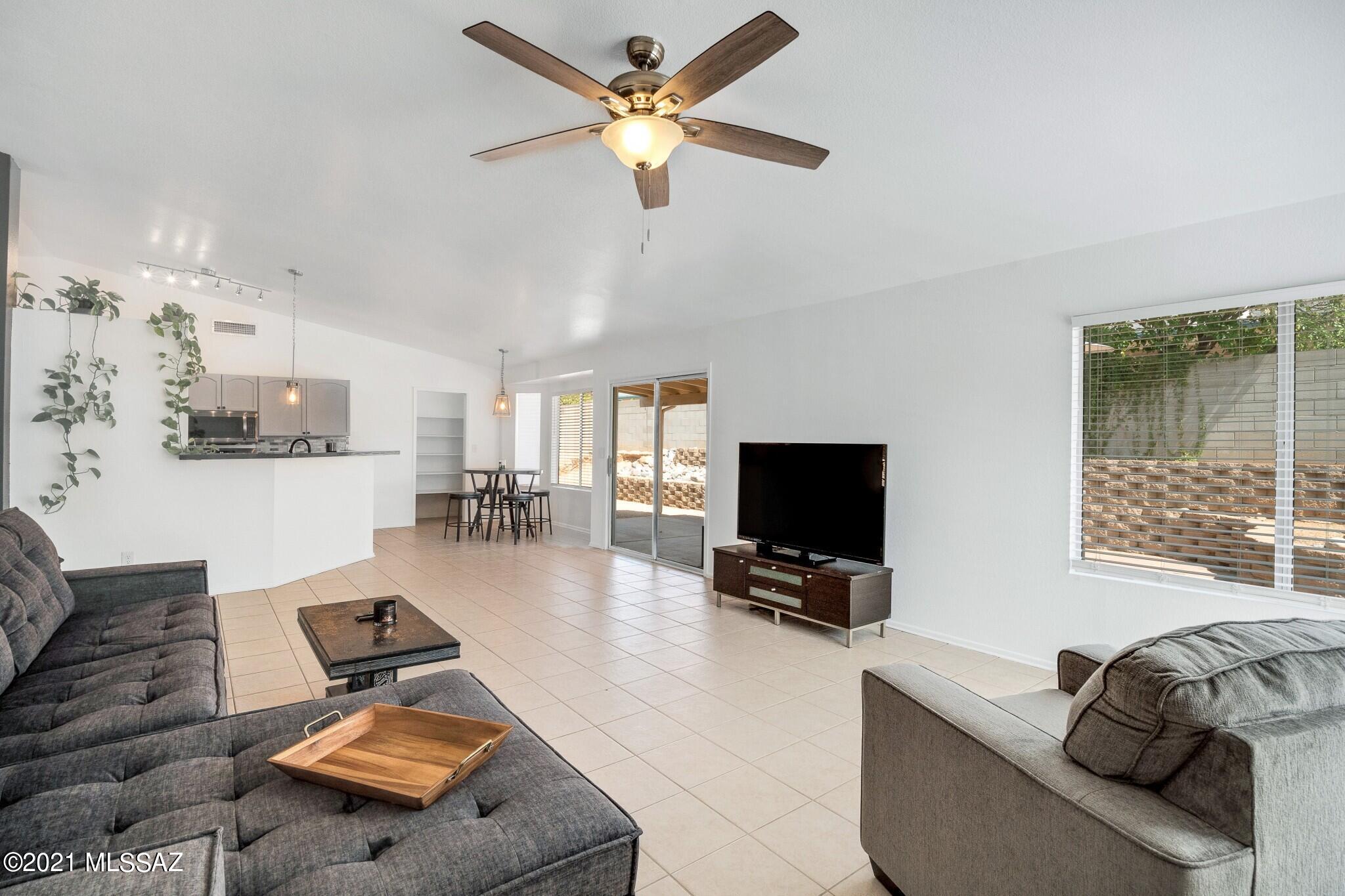 9671 East Azuma Way Tucson, AZ 85747 - Photo 10 of 31 a living room with furniture ceiling fan and a window