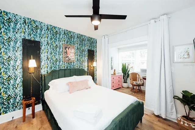 a bed room with a bed mirror and a table