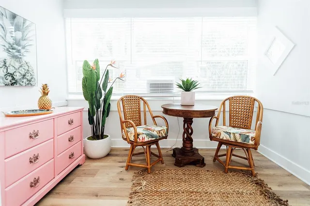 a living room with furniture and a potted plant