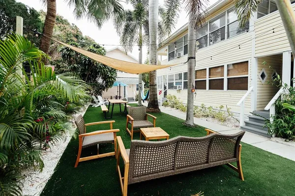 a view of a chair and table in backyard of the house