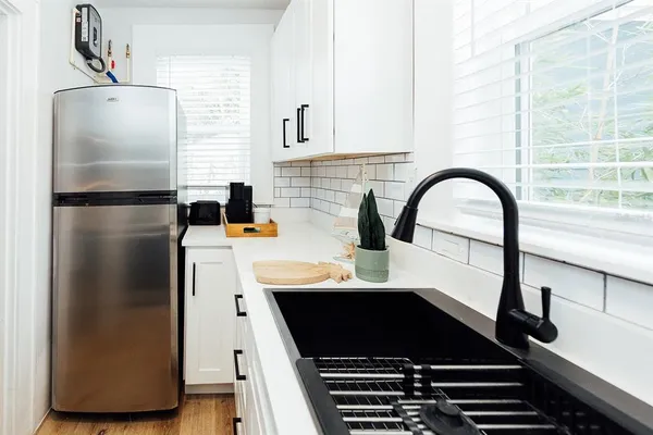 a kitchen with a refrigerator and a sink