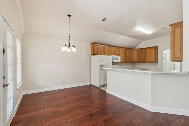 a view of a kitchen with wooden floor