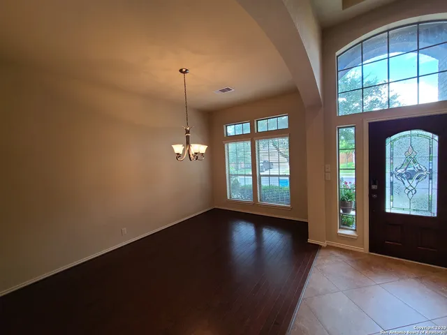 an empty room with windows and entrance