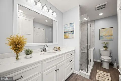 a bathroom with a sink vanity and a mirror