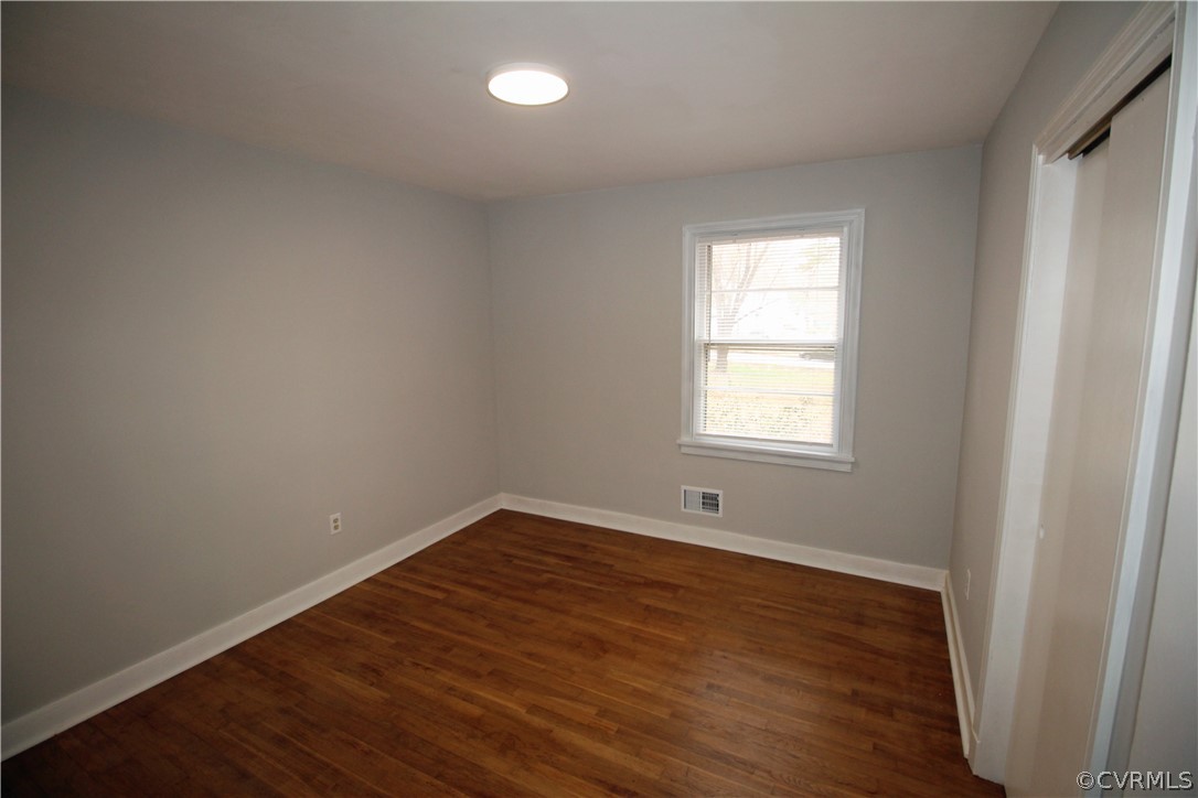 12821 Old Buckingham Road Midlothian, VA 23113 - Photo 27 of 50 an empty room with wooden floor and windows