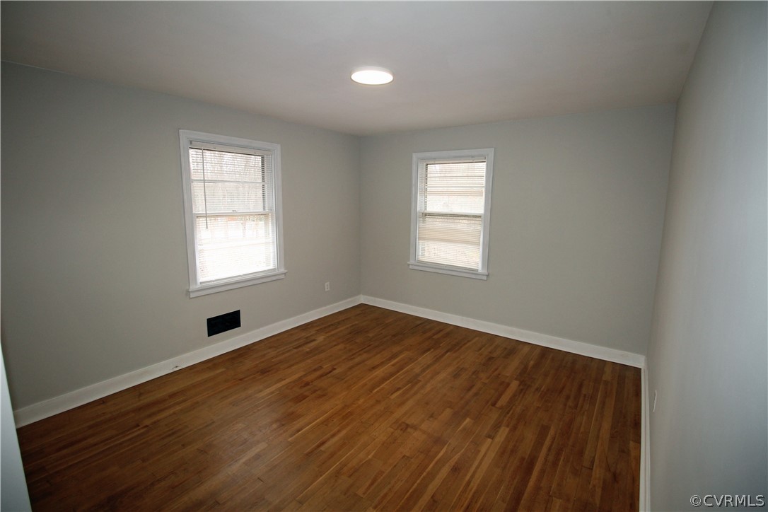12821 Old Buckingham Road Midlothian, VA 23113 - Photo 30 of 50 an empty room with wooden floor and windows