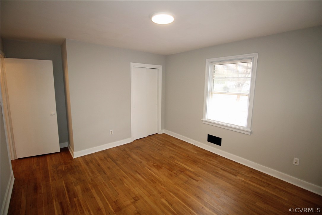12821 Old Buckingham Road Midlothian, VA 23113 - Photo 31 of 50 an empty room with wooden floor and windows