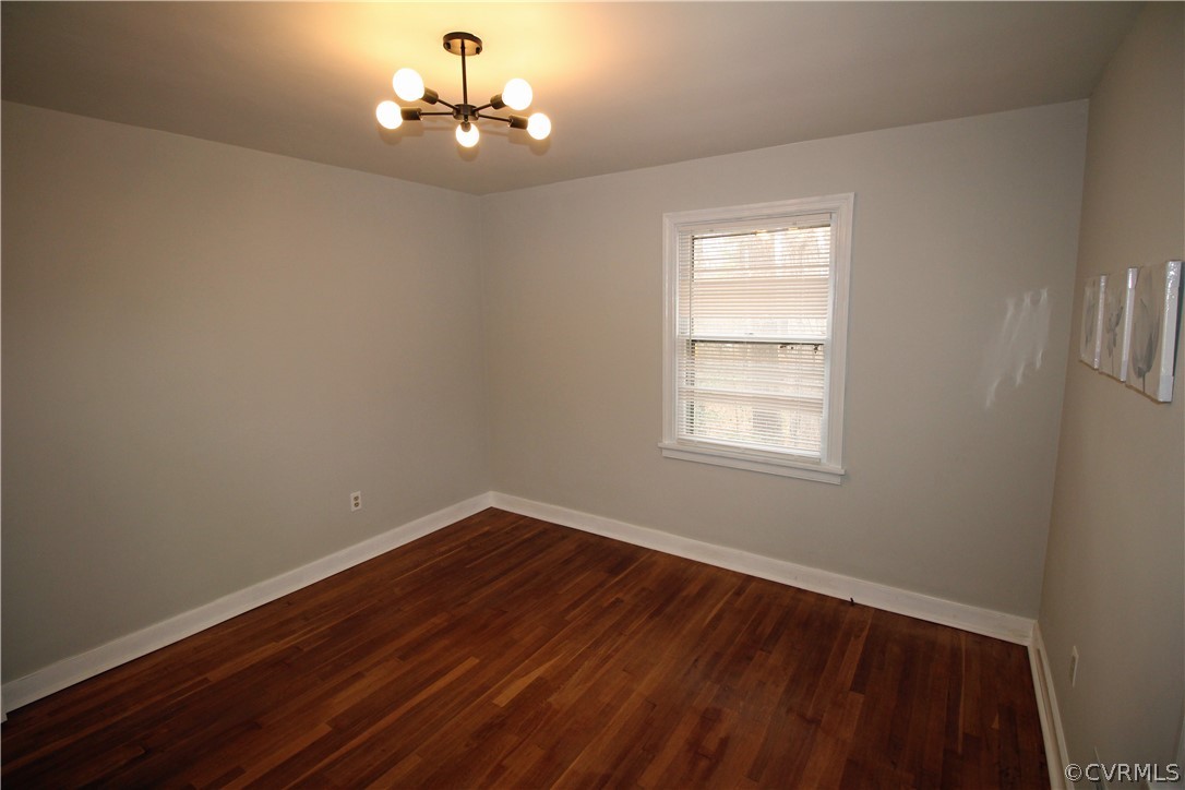 12821 Old Buckingham Road Midlothian, VA 23113 - Photo 34 of 50 a room with wooden floor chandelier and window