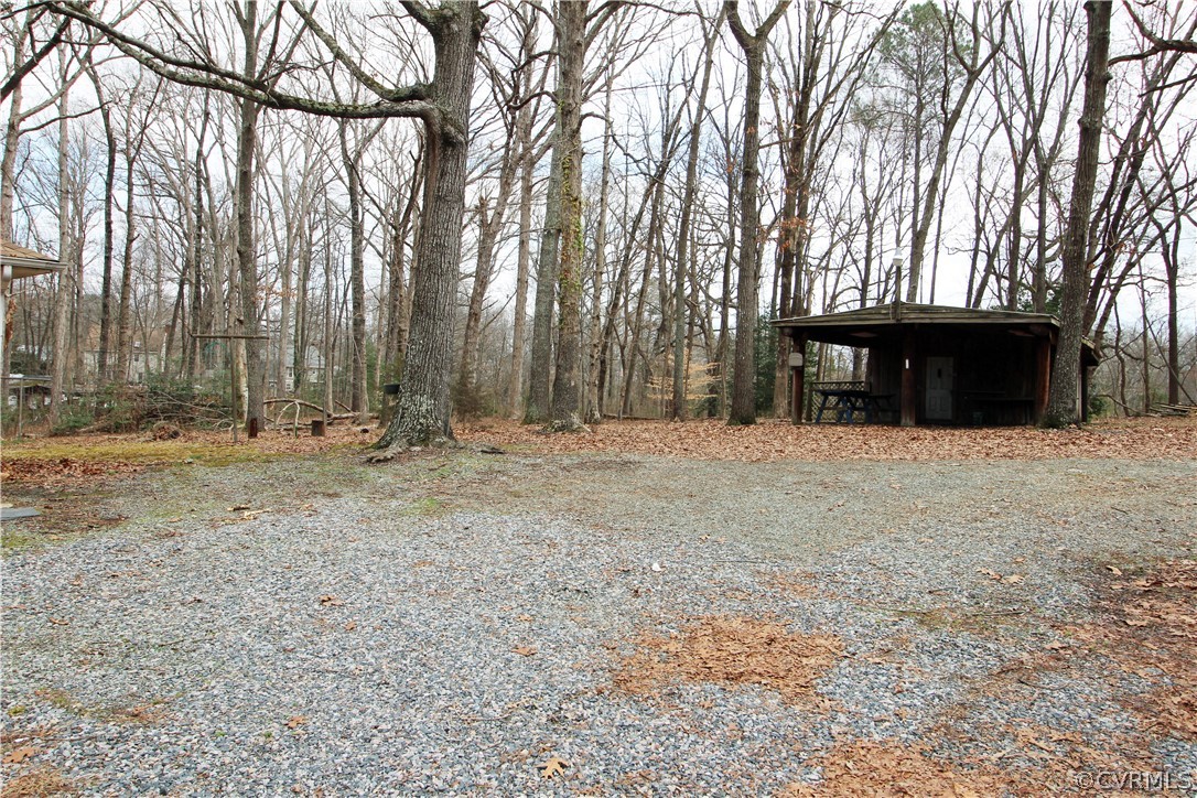 12821 Old Buckingham Road Midlothian, VA 23113 - Photo 40 of 50 a view of wooden house with large trees