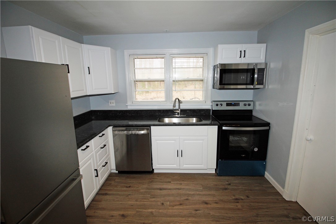 12821 Old Buckingham Road Midlothian, VA 23113 - Photo 6 of 50 a kitchen with granite countertop white cabinets and black appliances