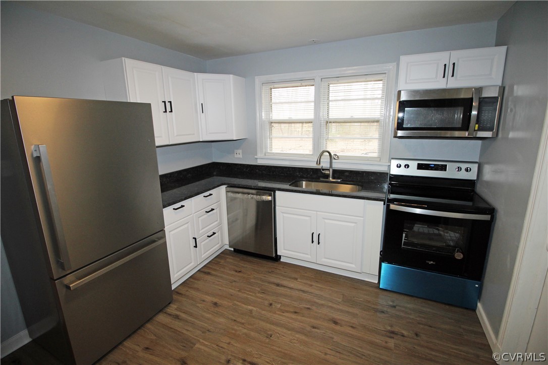 12821 Old Buckingham Road Midlothian, VA 23113 - Photo 7 of 50 a kitchen with white cabinets and stainless steel appliances