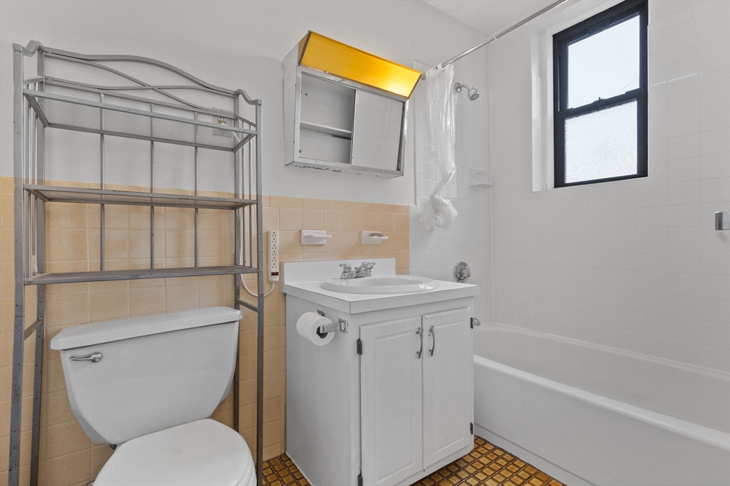 466 Commonwealth Avenue, Unit 305 Boston, MA 02215 - Photo 7 of 14 a bathroom with a sink a toilet and shower