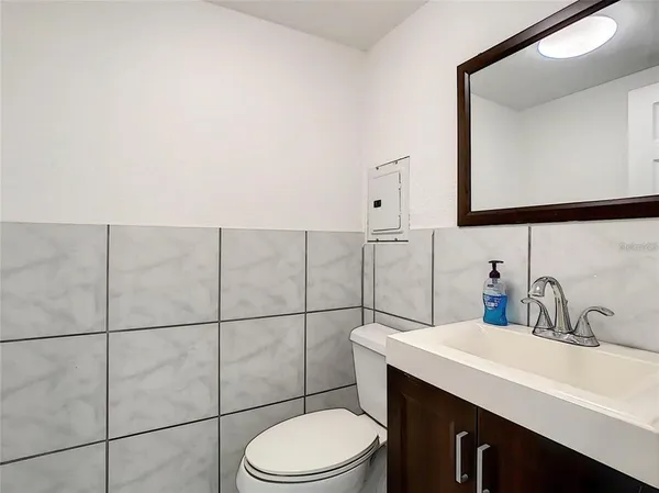 a bathroom with a sink toilet and mirror
