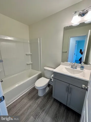 a bathroom with a sink mirror vanity and toilet