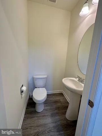 a white toilet sitting in a bathroom