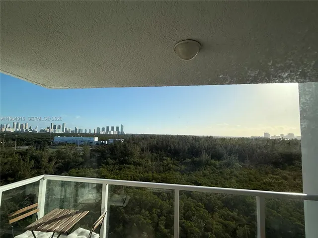 a view of a balcony with wooden floor and city view