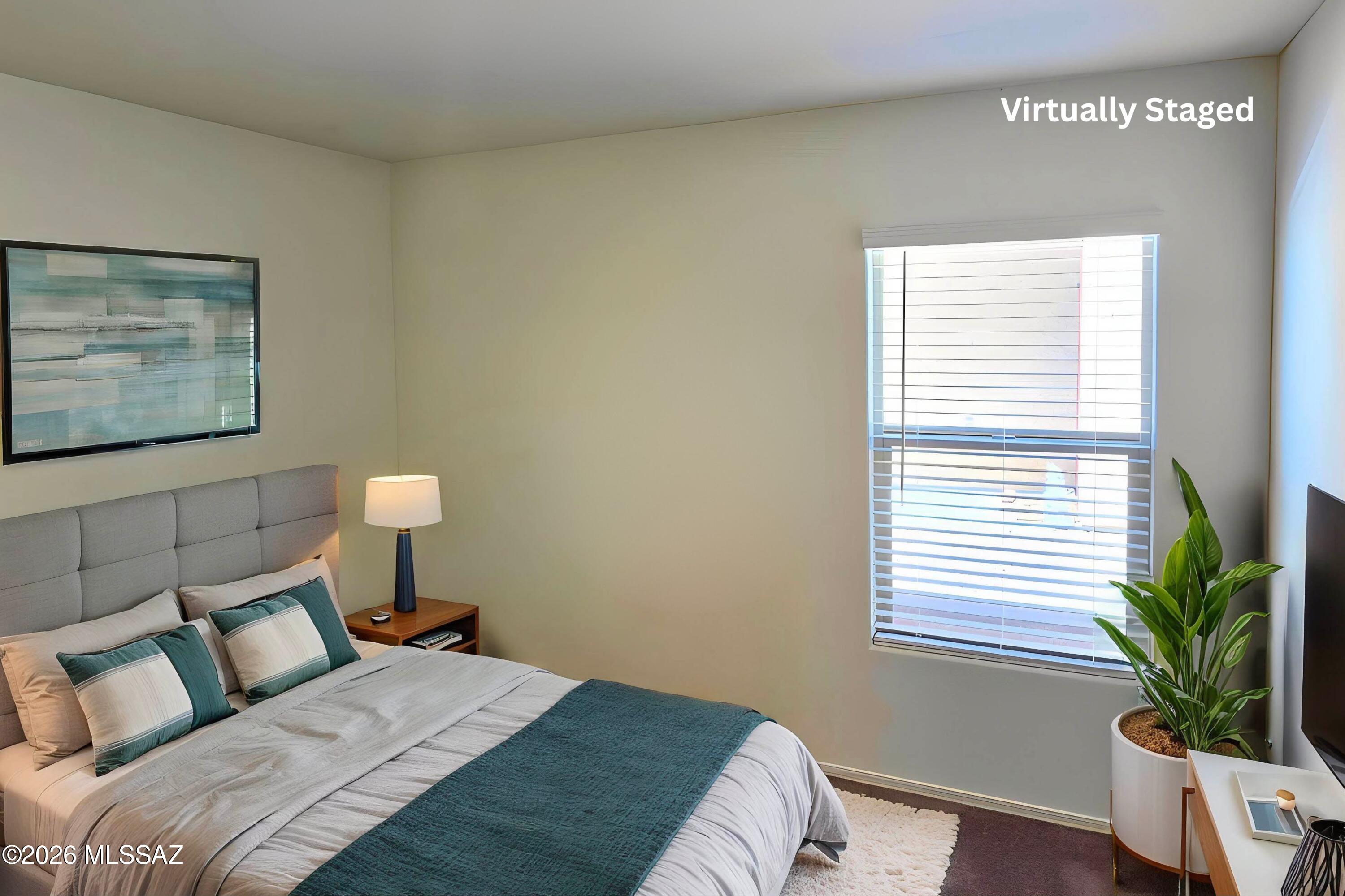 6343 South Rigby Way Tucson, AZ 85746 - Photo 16 of 29 a bedroom with a bed and a potted plant