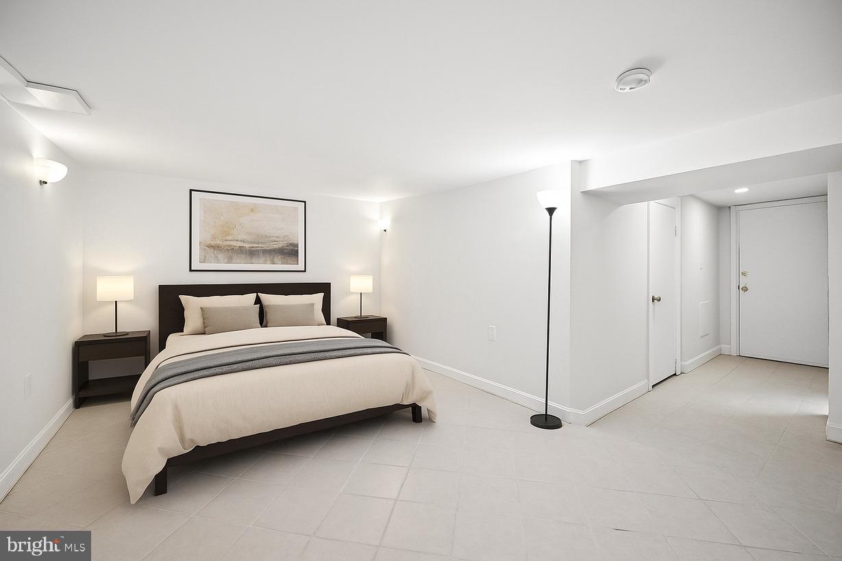 3921 22nd Street Northeast Washington, DC 20018 - Photo 21 of 28 a spacious bedroom with a bed and a painting